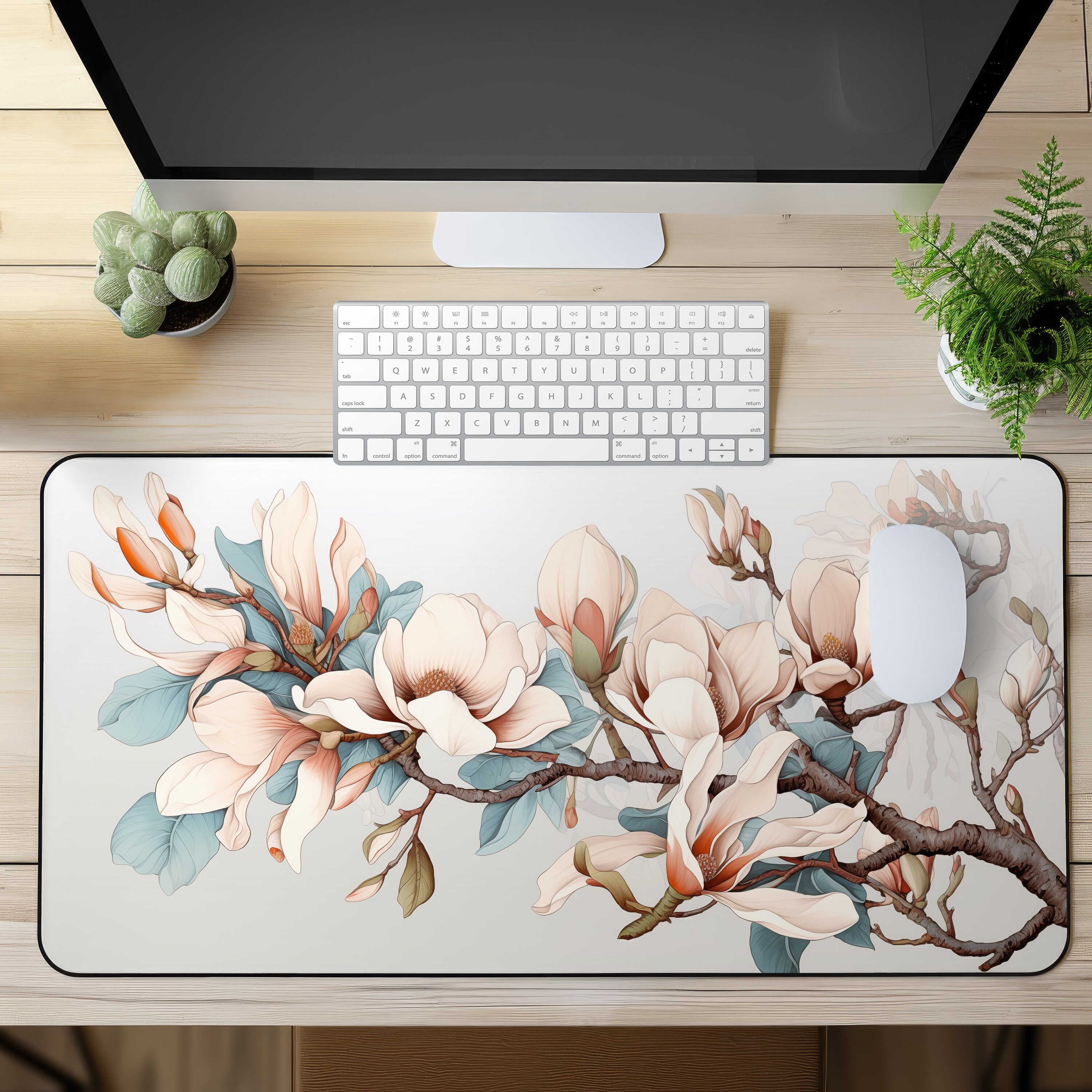 Magnolia Flowers Desk Mat on a desk with keyboard and mouse